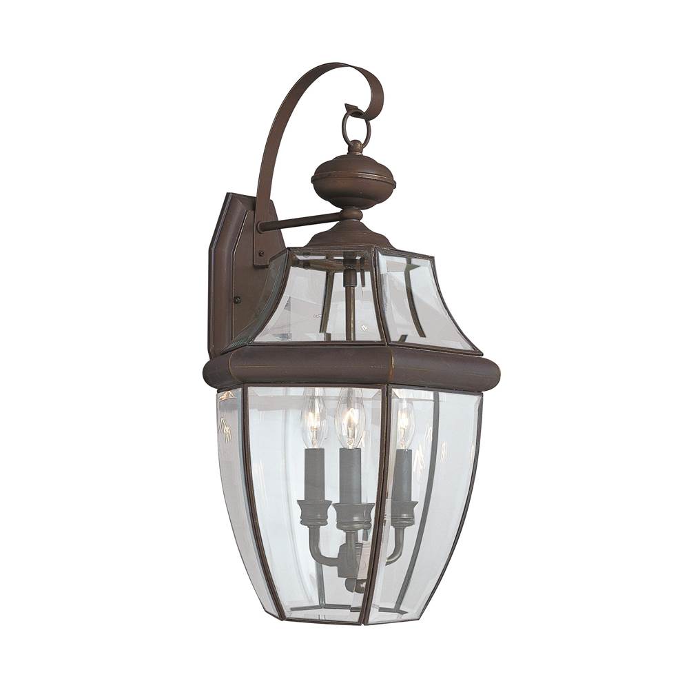 Generation Lighting Lancaster Traditional 3-Light Outdoor Exterior Wall Lantern Sconce In Antique Bronze Finish With Clear Curved Beveled Glass Shade
